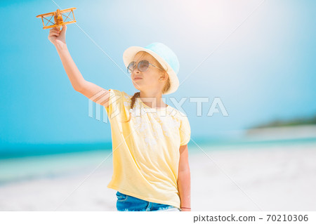 Cute little girl at beach during caribbean vacation 70210306