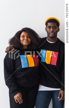 Happy African American woman and man have relationships, toothy smile, happy to meet with friends, dressed casually on white background. Emotions and friendship concept. Happy African American woman and man have relationships, toothy smile, happy to meet with friends, dressed casually on white background. Emotions and friendship concept. 70210474