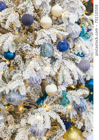 Christmas-tree decorations on a christmas fir-tree. Holidays and decor concept. 70210508