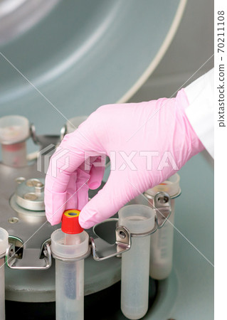Doctor puts test tube. Doctor puts test tube. 70211108