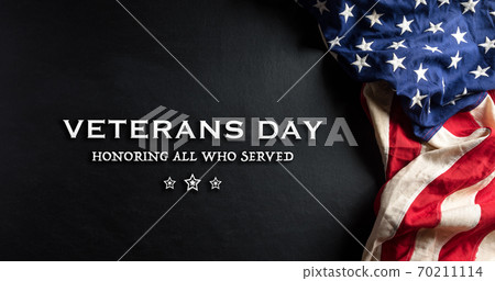 Happy Veterans Day concept. American flags against a blackboard background. November 11. 70211114