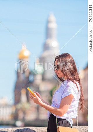 Woman at the summer waterfront in Saint Petersburg outdoors 70211311