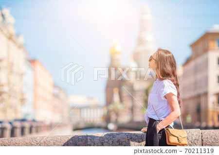 Woman at the summer waterfront in Saint Petersburg outdoors 70211319