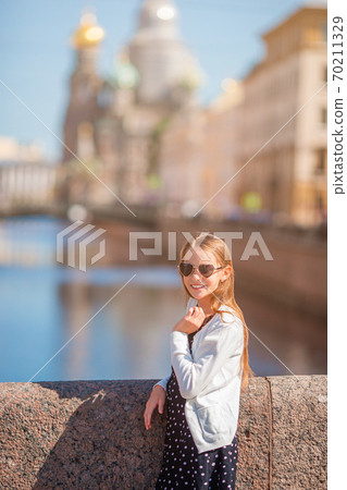 Girl at the summer waterfront in Saint Petersburg outdoors Girl at the summer waterfront in Saint Petersburg outdoors 70211329