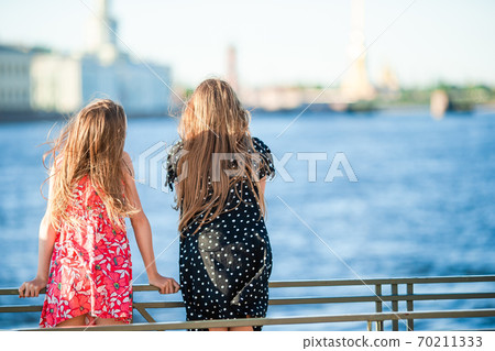 Children at the summer waterfront in Saint Petersburg Children at the summer waterfront in Saint Petersburg 70211333