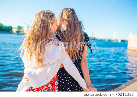 Children at the summer waterfront in Saint Petersburg Children at the summer waterfront in Saint Petersburg 70211336
