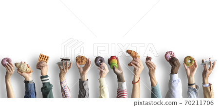 People are holding different desserts in their hands. The concept of food and sweets. People are holding different desserts in their hands. The concept of food and sweets. 70211706