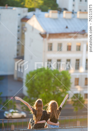 Cute girlson rooftop enjoying with view of beautiful sunset in Sankt Petersburg in Russia Cute girlson rooftop enjoying with view of beautiful sunset in Sankt Petersburg in Russia 70211975