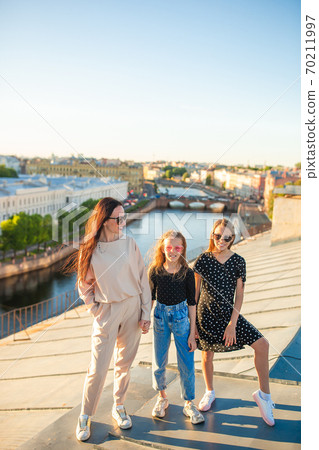 Family on rooftop enjoying with view of beautiful sunset in Sankt Petersburg in Russia Family on rooftop enjoying with view of beautiful sunset in Sankt Petersburg in Russia 70211997