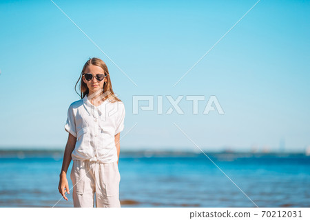 Young beautiful girl having fun on tropical seashore. 70212031