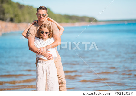 Little girl and happy dad having fun during beach vacation 70212037
