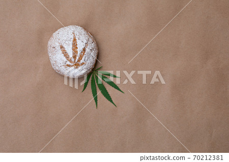 Pattern of cannabis leaf made with powdered sugar on the cookies on kraft background. Cannabis live resin extraction. Banner Pattern of cannabis leaf made with powdered sugar on the cookies on kraft background. Cannabis live resin extraction. Banner 70212381
