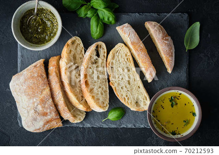 Mediterranean snacks set. Olives, oil, herbs and sliced ciabatta bread. Top view. Mediterranean snacks set. Olives, oil, herbs and sliced ciabatta bread. Top view. 70212593