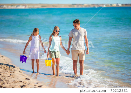 Happy beautiful family on a tropical beach vacation Happy beautiful family on a tropical beach vacation 70212881