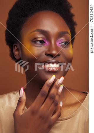 pretty young african american woman with curly hair posing cheerful gesturing on brown background, lifestyle people concept pretty young african american woman with curly hair posing cheerful gesturing on brown background, lifestyle people concept 70213424