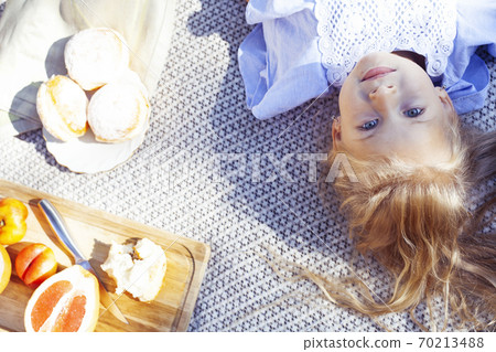 little cute blond girl outside having fun on picnic, lifestyle people concept little cute blond girl outside having fun on picnic, lifestyle people concept 70213488