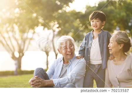 asian grandparents enjoying good time with grandson 70213587