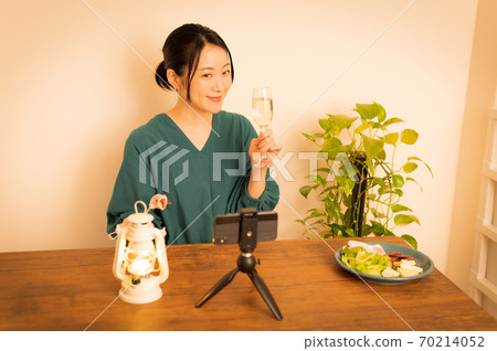 Woman drinking online at night Woman drinking online at night 70214052