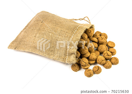 Traditional pepernoten treats in jute bag on white background 70215630