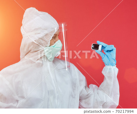 female doctor in a chemical suit. concept of medicine. red background 70217994