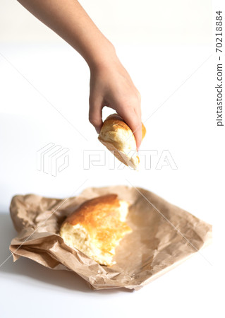 The child holds a piece of lavash in his hands. Traditional Asian food on a white background. Yeast-free baked goods. Healthy food The child holds a piece of lavash in his hands. Traditional Asian food on a white background. Yeast-free baked goods. Healthy food 70218884