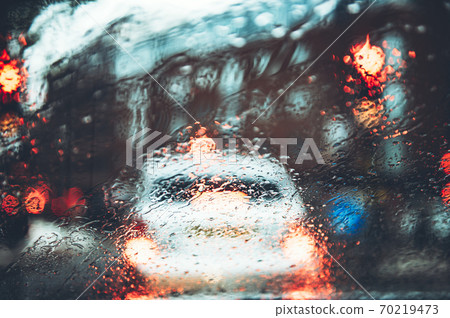 Blurred city street during dark rainy day 70219473