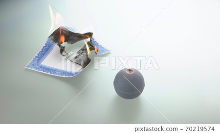 Round candle and burning stock certificate. Round candle and burning stock certificate. 70219574