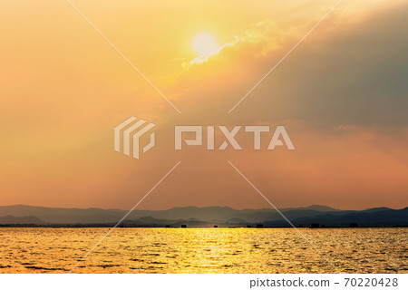 Sun shines golden in the clouds at summer 70220428