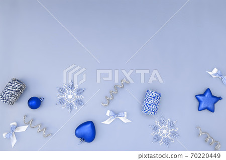 Flat composition of Christmas decorations in red, white, gold and silver on a beige background. 70220449