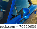 close-up of the rearview mirror of a blue sports car 70220639