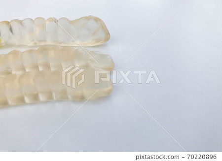 gummy worms lie on a white matte background gummy worms lie on a white matte background 70220896