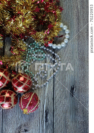 Christmas Decoration isolated on the wooden background. Balls , beads and tinsel Christmas Decoration isolated on the wooden background. Balls , beads and tinsel 70220953