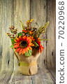 Orange decorative sunflower and two acorns isolated on the wood background. Thnksgining content 70220968