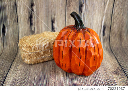 Colorful pumpkin and a hey stack isolated on the wood background. Thanksgiving content Colorful pumpkin and a hey stack isolated on the wood background. Thanksgiving content 70221987