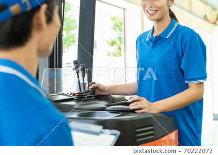 Female driver driving a forklift 70222072