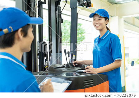 Female driver driving a forklift Female driver driving a forklift 70222079