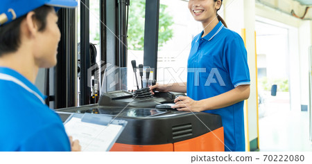 Female driver driving a forklift Female driver driving a forklift 70222080