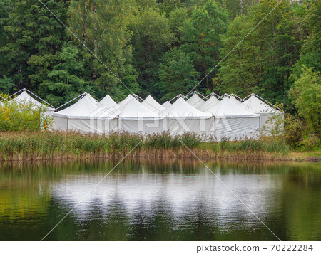 A view of the white tents by the water 70222284