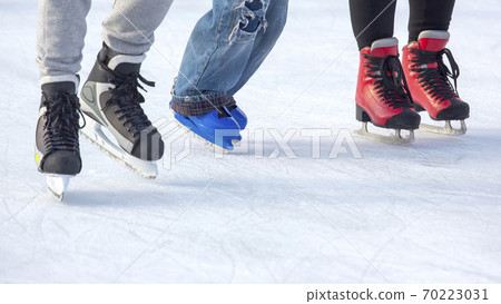 people ice skating on an ice rink. Hobbies and sports. Vacations and winter activities. 70223031