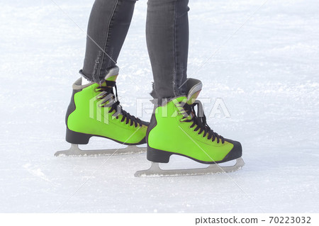 girl ice skating on an ice rink. Hobbies and sports. Vacations and winter activities. girl ice skating on an ice rink. Hobbies and sports. Vacations and winter activities. 70223032