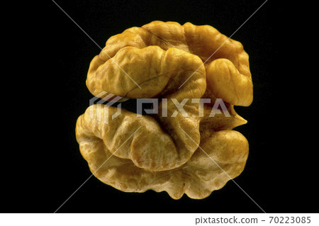 walnut closeup on a black background walnut closeup on a black background 70223085