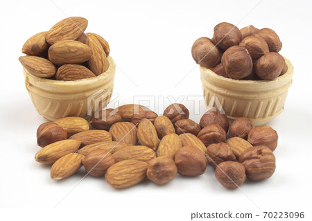 Different nuts in a waffle basket on a white background. Vitamin wholesome food. 70223096