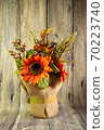 Bouquet of decorative red sunflowers red isolated on wood background. Thanskgiving concept. Holidays 70223740