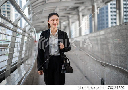 business woman walking in city 70225892