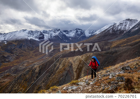 Girl Backpacking along Scenic Hiking Trail 70226701