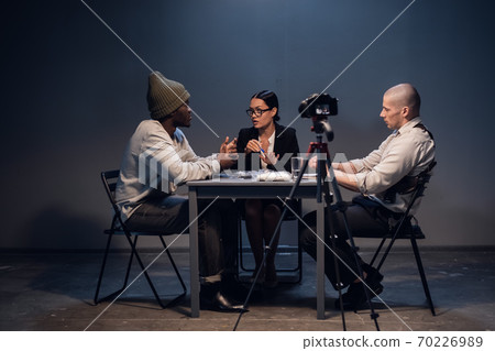 The interrogation of a well-known drug dealer is filmed in the presence of a lawyer at a police station The interrogation of a well-known drug dealer is filmed in the presence of a lawyer at a police station 70226989