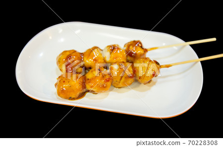 Grilled meatballs or pork on skewers with chili sauce in white plate, focus selective 70228308