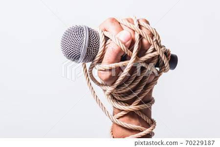 Hand holding microphone and have roped on fist hand Hand holding microphone and have roped on fist hand 70229187