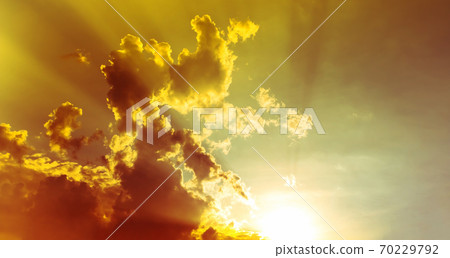 sky and clouds nature background, bright yellow sunset light in overcast sky with soft clouds sky and clouds nature background, bright yellow sunset light in overcast sky with soft clouds 70229792