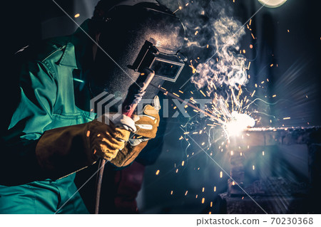 Metal welding steel works using electric arc welding machine 70230368